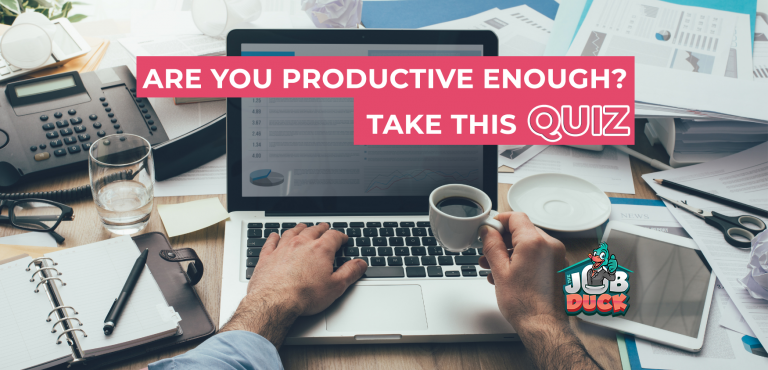 Man holding a coffee cup in front of the computer.