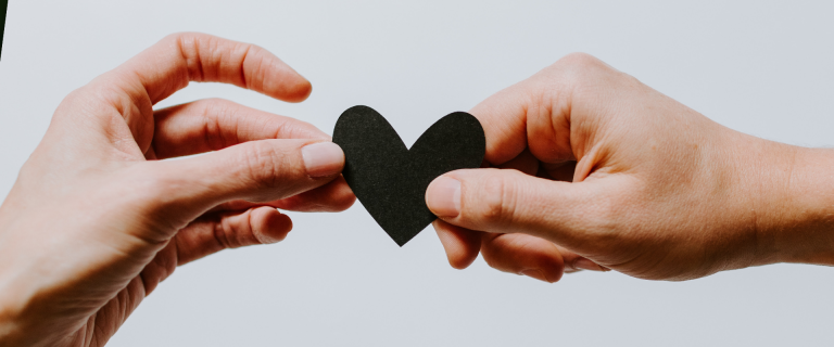 Holding a black heart.